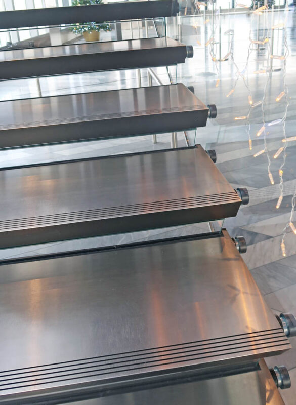 Design-build Structural Glass Guardrail With Floating Stainless Steel Treads.